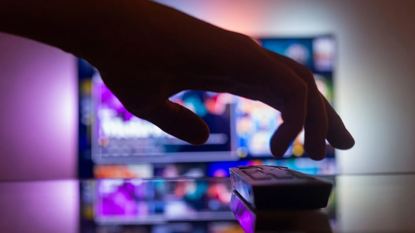 TV with streaming with a remote control near the wall in the room